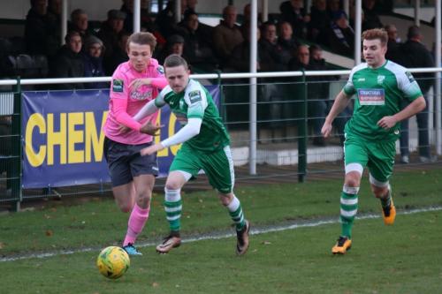 Leatherheads Tom Richards holds off Mickey Parcell (L) as Sam Blackman covers