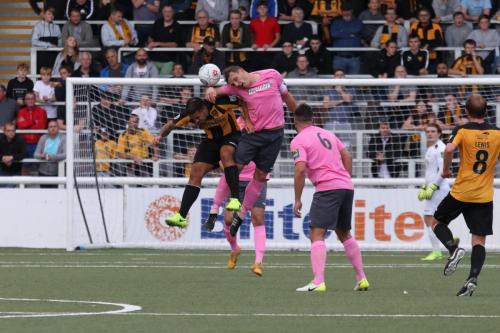 Enfields Darren Purse heads clear from Jai Reason (L)