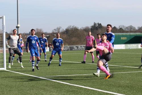 Enfields Dan Rumens (pink, R) lifts the ball back into the Margate box