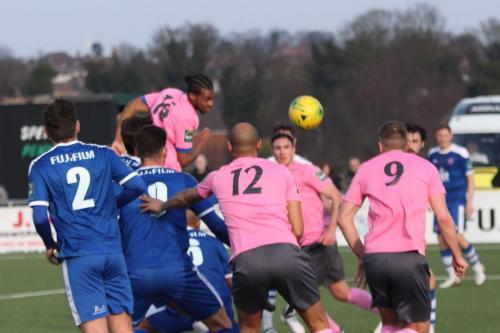 Enfields Dernell Wynter heads goalwards but the ball deflects into the net off Brad Wadkins (9) who is offfside