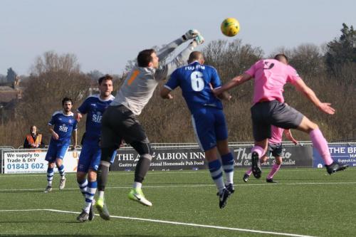 Margate keeper Lenny Pidgeley punches clear from Brad Wadkins and Tom Wynter (6)