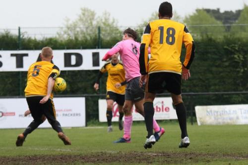 Mersthams Liam Harwood (L) blocks from Sam Youngs