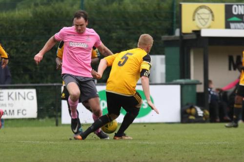 Mersthams Liam Harwood (R) challenges Matt Johnson