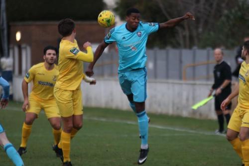 Mets Gavin James (blue) and Enfields Sam Youngs