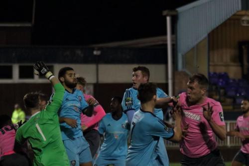 After heading  Enfield into the lead, Brad Wadklns (pink) collides with Jamie Autorino who came off second best and took no further part in the game