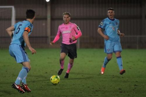 Enfields Ryan Blackman (pink) and Mets Olli Robinson (L) and Callum Keeley
