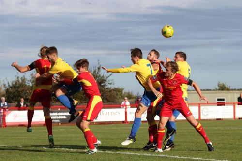 Enfields Dan Rumens, Mickey Parcell and Darren Purse (yellow, L-R) challenge at a corner