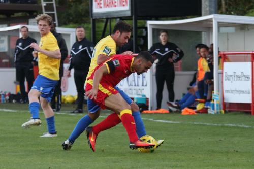 Enfields Jack Higgs (yellow) challenges Luke Ingram