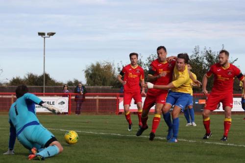 Enfields Sam Youngs (yellow) cant reach a through ball