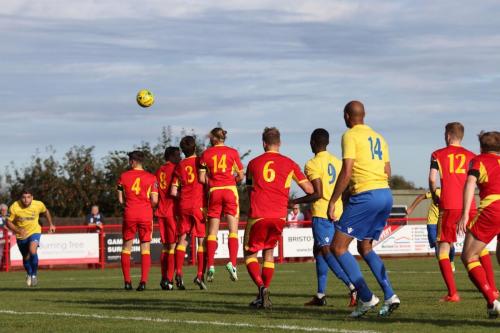 Jack Higgs curls a free kick over the wall for the second Enfield goal