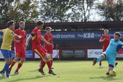 Needhams Daryl Coakley (3) deflects a cross past his own keeper