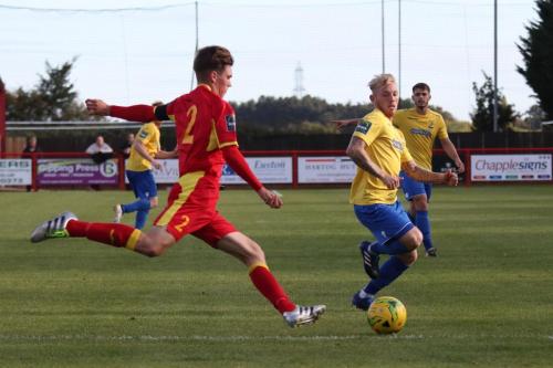 Needhams Jake Dye clears from Ryan Blackman