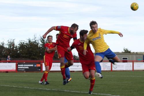 Needhams Sam Nunn (6) heads clear from Mickey Parcell