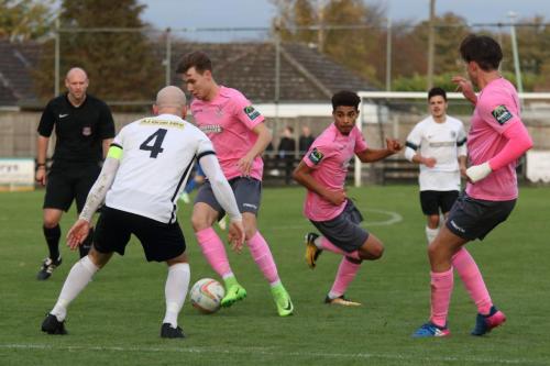 Enfields Ben Ward-Cochrane (pink, L) takes the ball past Scott Bridges (4)