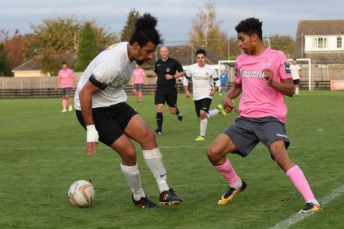 Enfields Montell Moore (R) pushes the ball past Adam Murray