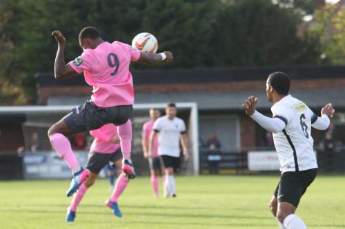 Enfields Ryan Blake (L) heads the ball into the penalty area