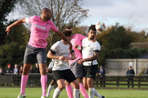 Enfields Simon Thomas (L) heads on goal