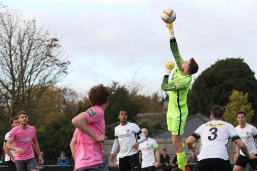 Royston keeper Joe Welch palms a cross to safety