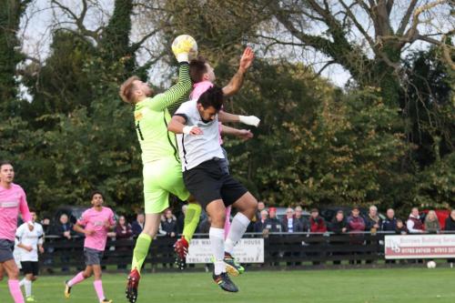 Royston keeper Joe Welch reaches the ball ahead of Adam Murray and Enfields Ben Ward-Cochrane