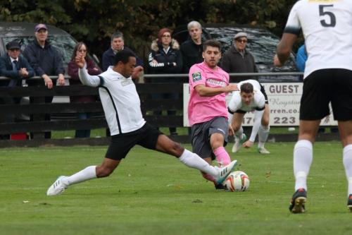 Roystons Ed Asafu-Adjaye (L) blocks John Kyriacous shot