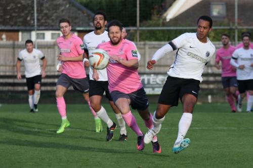 Roystons Ed Asafu-Adjaye (R) plays the ball back under pressure from Drew Roberts