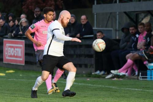 Roystons Scott Bridges clears from Montell Moore