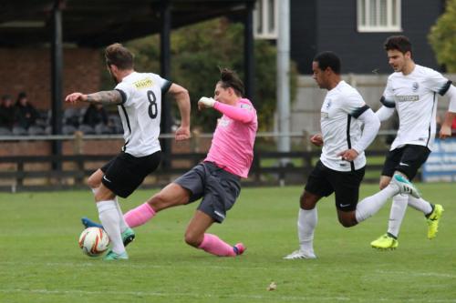 Roystons Scott Thomas (L) challenges Sam Youngs