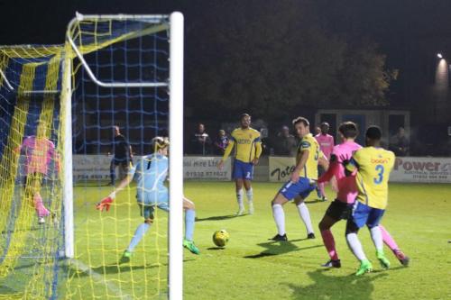 A cross from Enfields Mickey Parcell (pink, L) passes untouched through the six-yard area