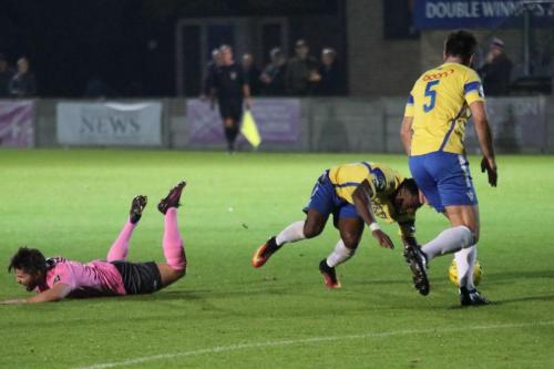 Enfields Drew Roberts (L) and Staines Tyrell Miller-Rodney collide in what the referee defined to be a legal shoulder charge