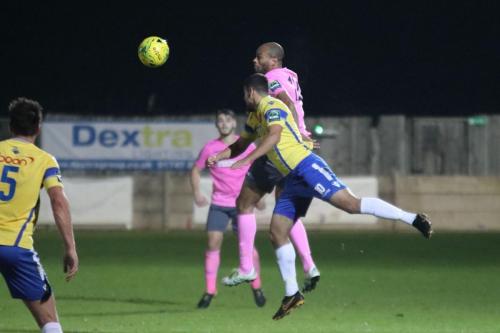 Staines Mo Bettamer (yellow) challenges Simon Thomas