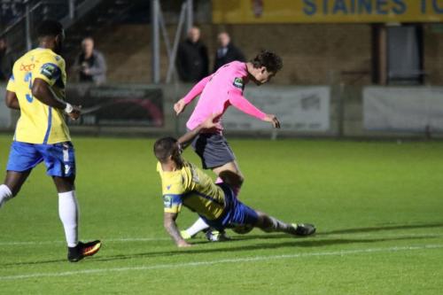 Staines Tommy Brewer (yellow) tackles Mickey Parcell