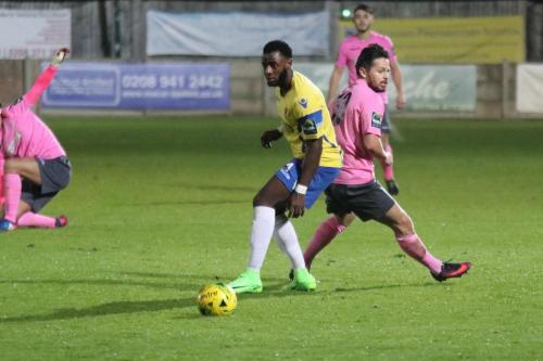 Staines Tyrell Miller-Rodney (yellow) and Enfields Drew Roberts