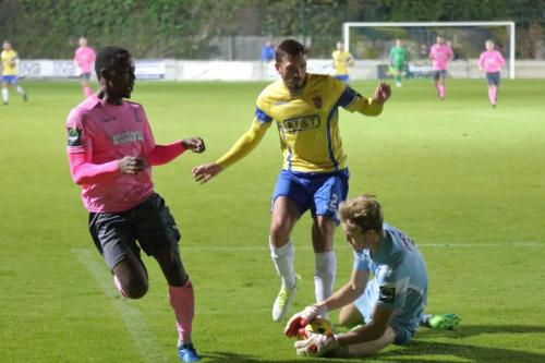 Staines keeper Liam Driscoll collects the ball ahead of Ryan Blake (L) and Josh Webb