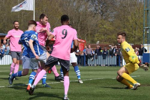 Brad Wadkins (pink, centre) opens the scoring for Enfield