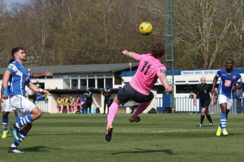 Enfields Aaron Greene tries a scissor kick but send the ball high over the bar
