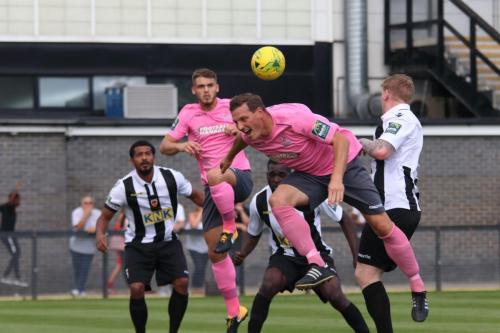 Enfields Dan Rumens (pink, L) and Darren Purse challenge at a set pieece