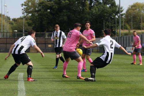 Enfields Drew Roberts (11) shields the ball from Dan Clements (2) and Eddie Dines