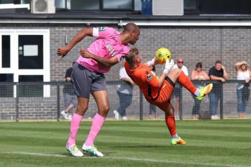 Enfields Simon Thomas (L) and Tooting keeper Kyle Merson