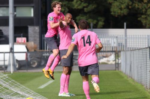 Scorer Simon Thomas is congratulated by Aaron Greene (L) and John Kyriacou (14)