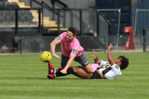 Tootings Ollie Bennett brings down Drew Roberts (pink)