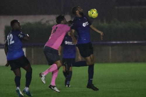 Wingates Afolabi Obafemi (12) and Marc Charles-Smith and Enfields Marion Noto