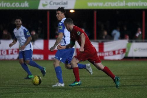 Enfields Craig Calver challenged by Darren Budd (red)
