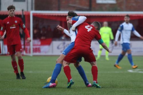 Enfields Sam Youngs (white) and Worthings Darren Budd wrestle for the ball