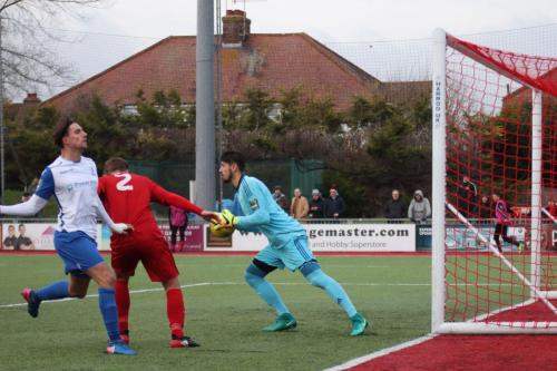 Worthing keeper Lucas Covolan collects the ball ahead of Joel Colbran (2) and Enfields Sam Youngs