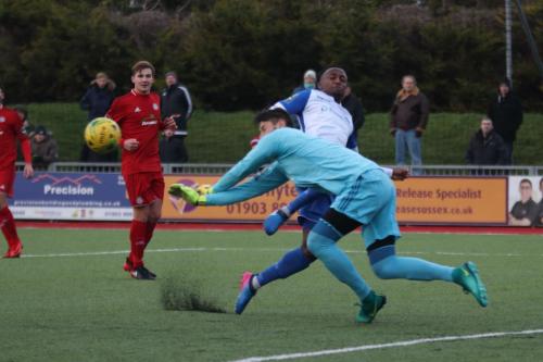 Worthing keeper Lucas Covolan saves from Ryan Blake, who was ruled offside
