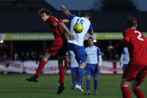 Worthings Joe Clark (L) and Enfields Craig Calver both miss a header