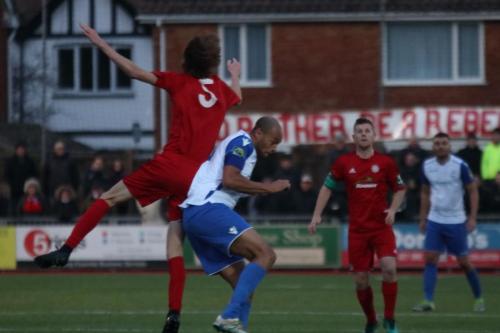 Worthings Joe Clark (red) challenges Simon Thomas