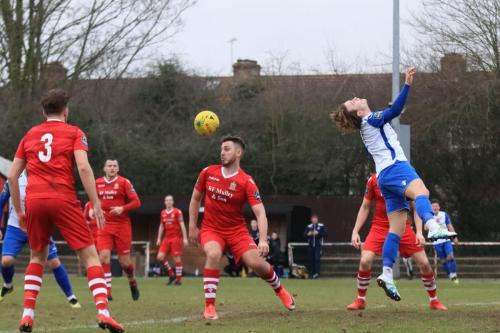 After his initial header is saved, Enfields Mickey Parcell (R) cant reach the rebound