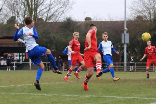 Enfields Sam Youngs (L) sees his shot blocked by Kenzer Lee