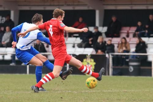 Enfields Sam Youngs (L) shoots as George Winn tries to block